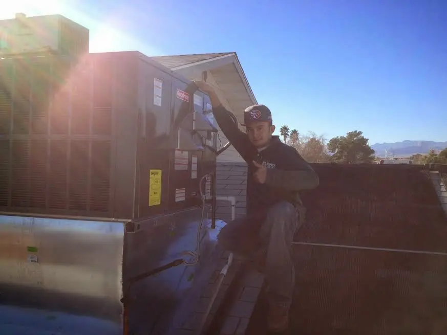 HVAC technician performing AC Tune-Up on a rooftop unit in North Whitehall
